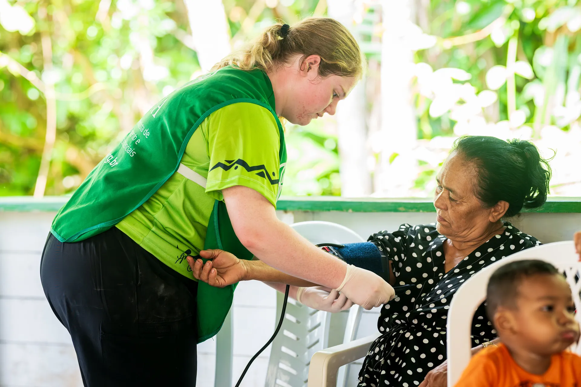 Woman taking another woman's blood pressure
