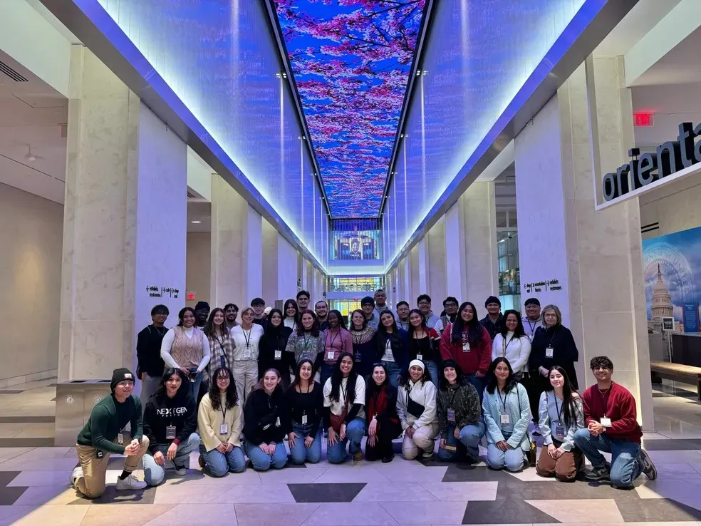 University singers under ceiling display