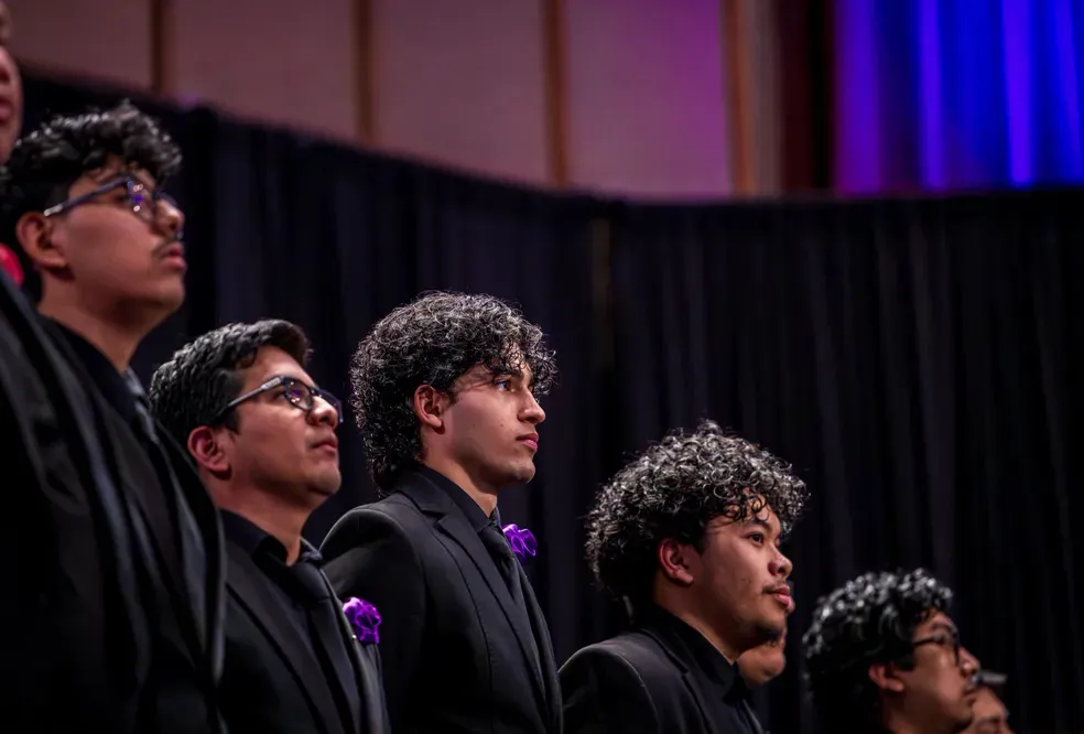 Five male singers staggered in a line