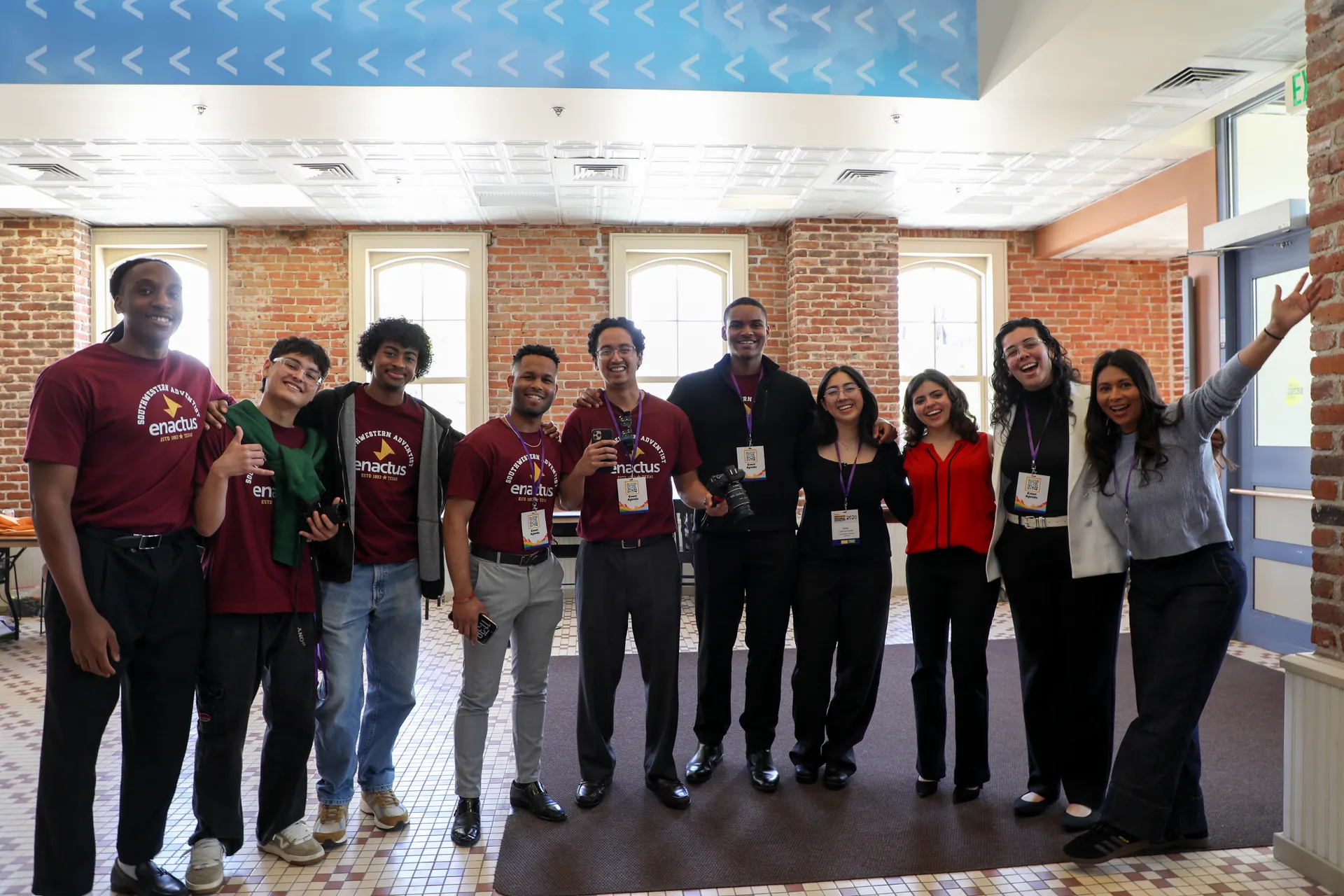 Team standing shoulder-to-shoulder, smiling at the camera