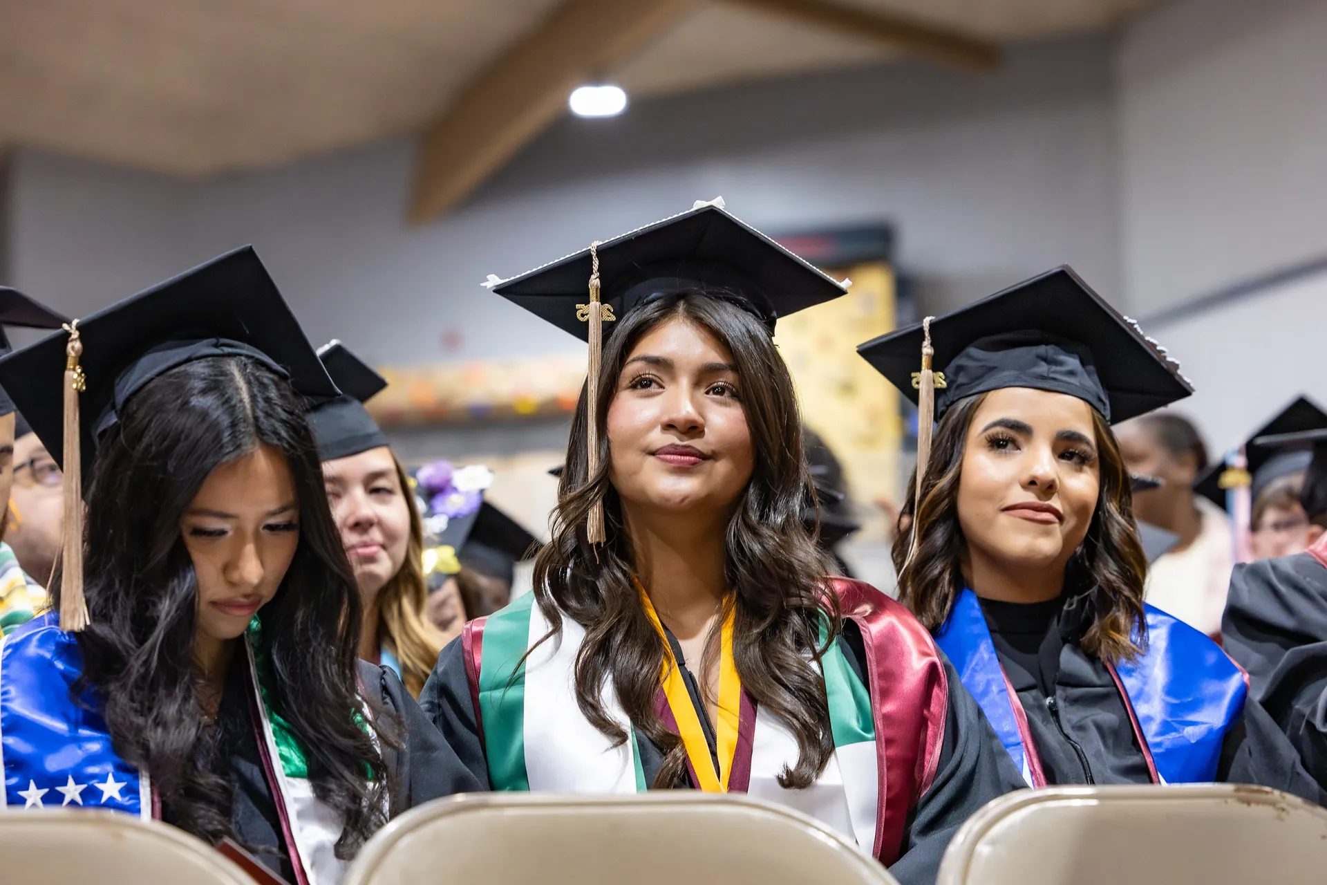 Students at graduation wearing regalia