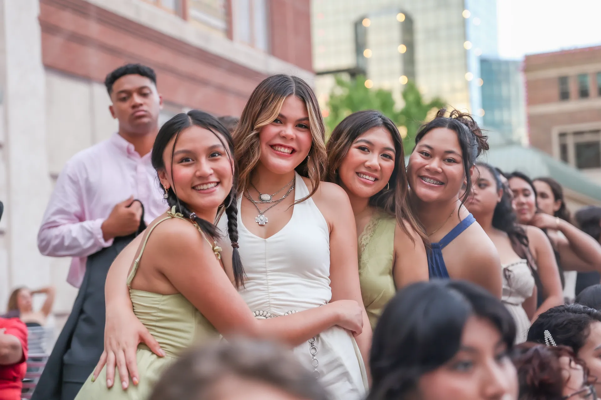 Group of four girls hugging and smiling