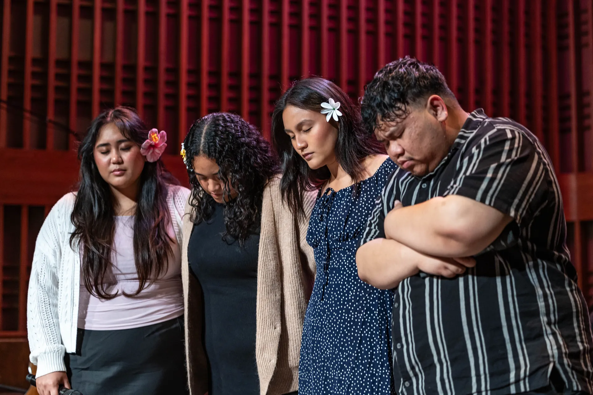 group on stage in prayer
