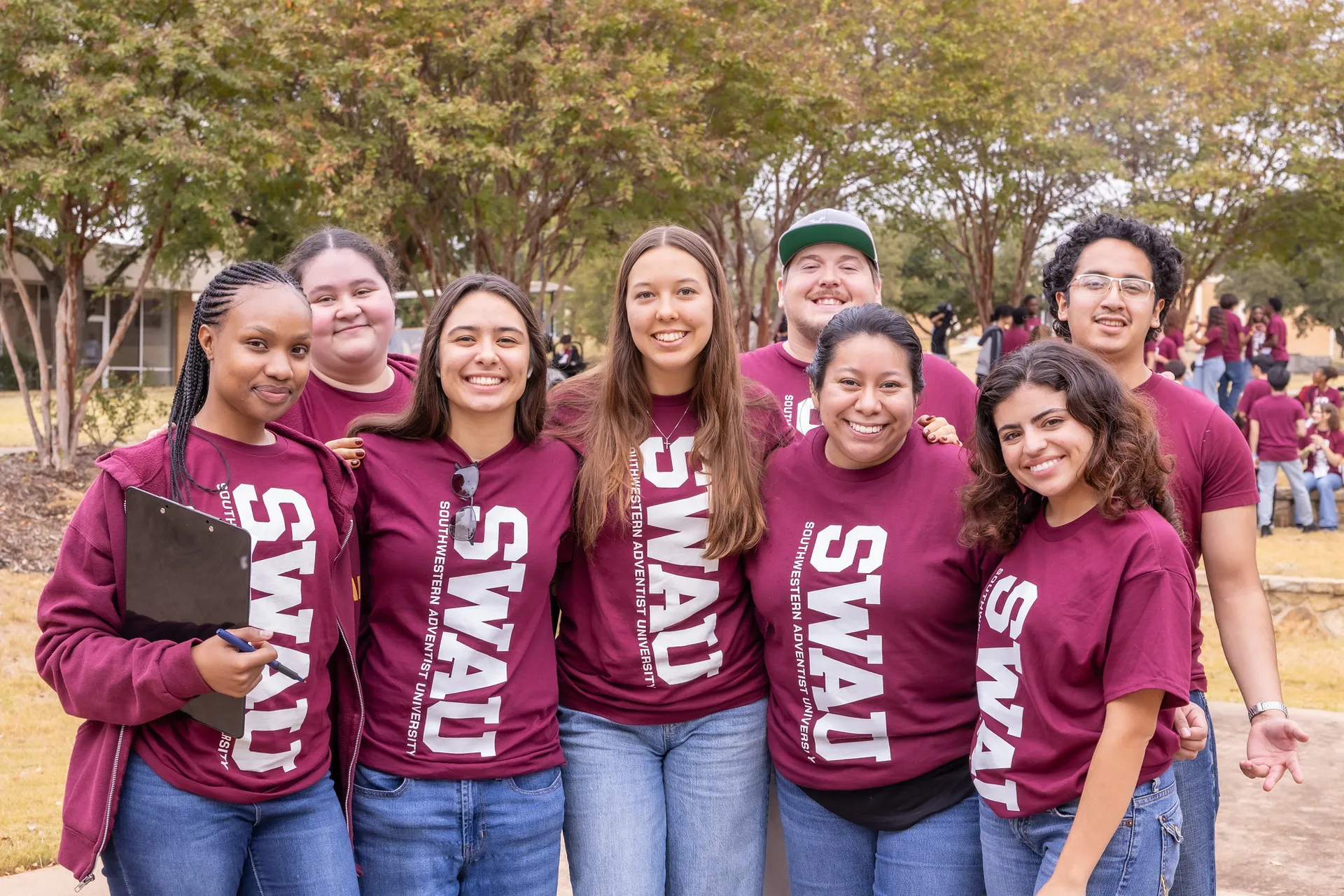 Several students in crimson shirts with SWAU on them