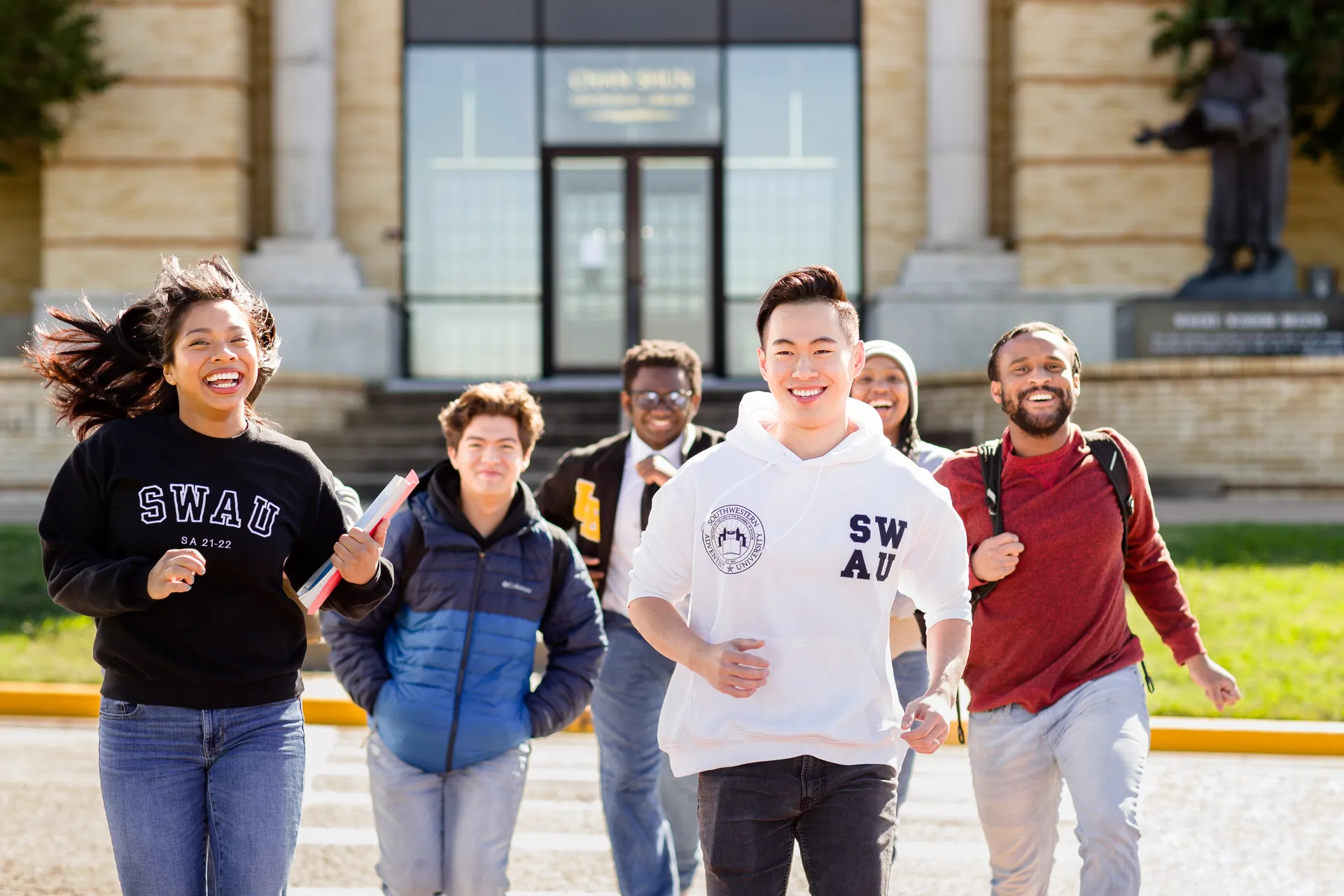 Students running at library entrance