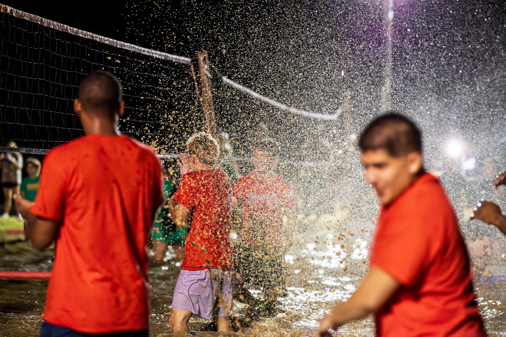 volleyball team sprayed by water
