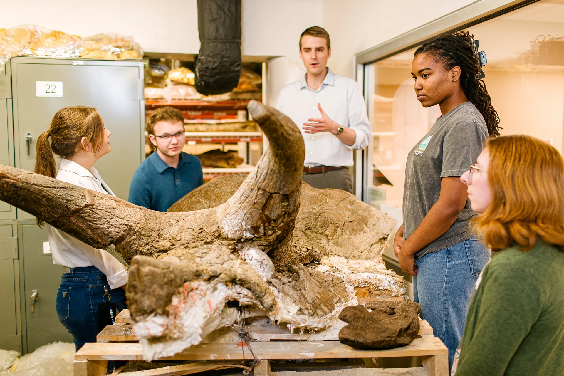 Professor leading a Dinosaur Museum Tour